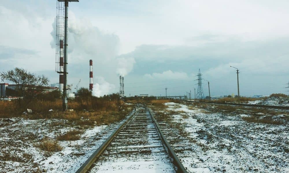 Abandoned railway tracks through an industrial area for a boundary line survey