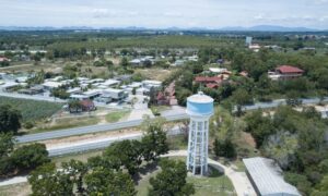 Drone land surveying capturing an aerial view of a historic water tower and surrounding landscape for restoration and mapping work