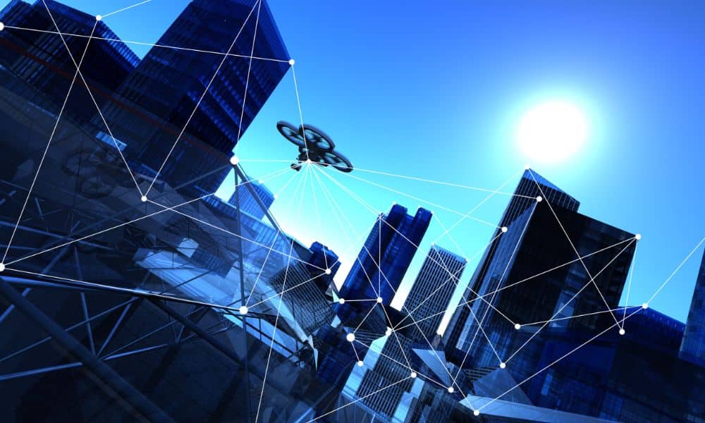 Aerial survey drone capturing land data over a modern city landscape