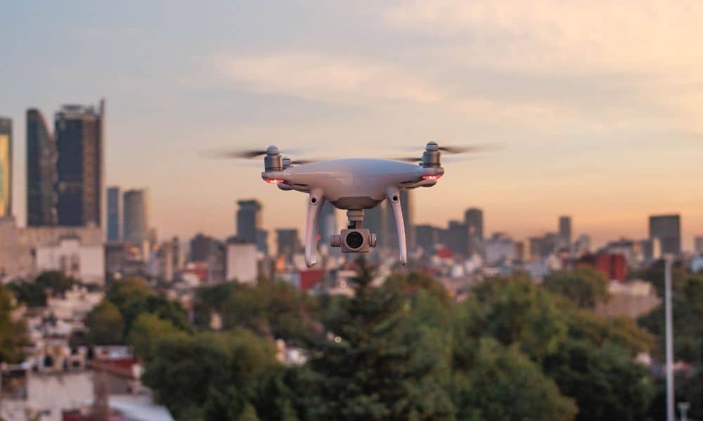A professional survey drone flying above an urban area during drone land surveying work