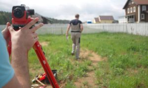 Homeowner hires survey companies near me to verify residential property boundary near backyard fence