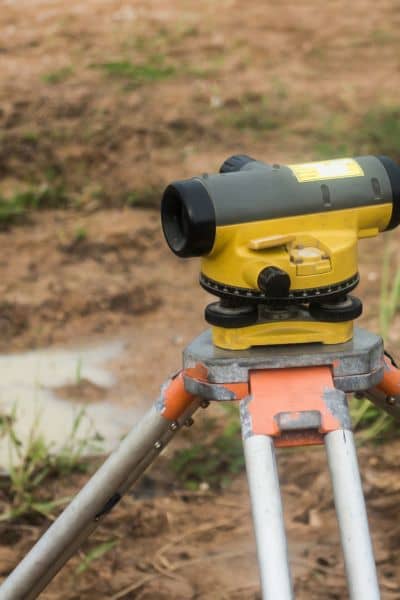 Survey equipment used to measure ground levels for an elevation certificate after storm-related flooding concerns
