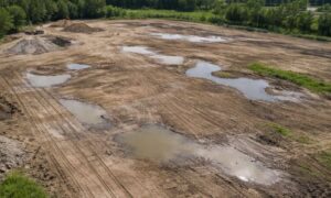 Flat construction site drainage issue aerial - ALTA SURVEY Ohio Aerial view of a flat construction site showing subtle water pooling and surface changes revealed through lidar mapping