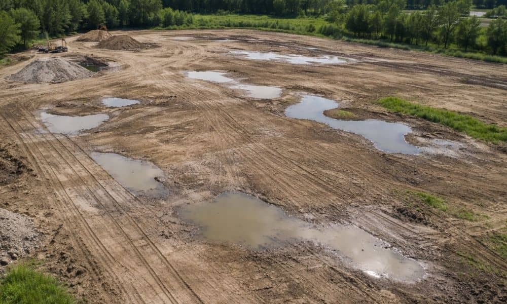Aerial view of a flat construction site showing subtle water pooling and surface changes revealed through lidar mapping