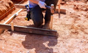 Survey stakes and string marking a house layout before construction begins