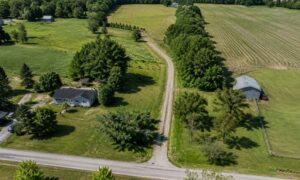 Aerial view of a rural landlocked parcel with an access road connecting the property to a public road