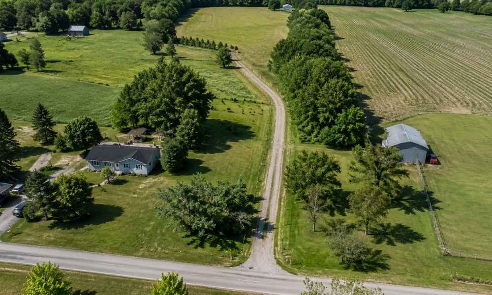 Aerial view of a rural landlocked parcel with an access road connecting the property to a public road