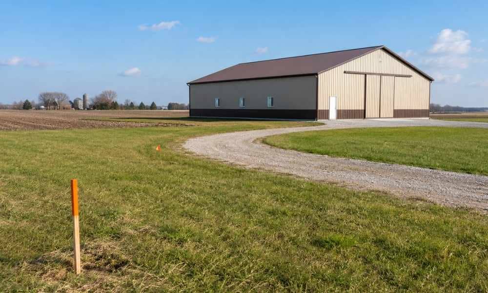 A large pole barn on a western Ohio farm with survey markers in the field