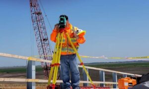 Elevation survey commercial site - ALTA SURVEY Ohio Surveyor using a total station on a construction site as part of an elevation survey